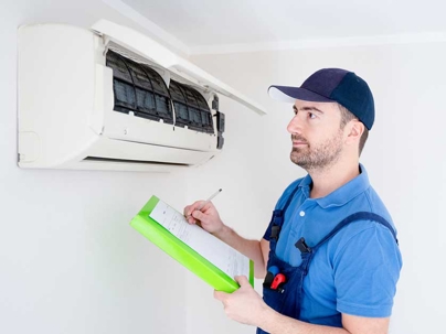 technician inspecting the indoor unit of a mini-split AC