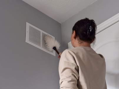 a woman cleaning their vent