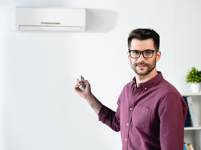 a man turning on their AC