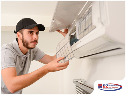 HVAC technician servicing a central air conditioning unit