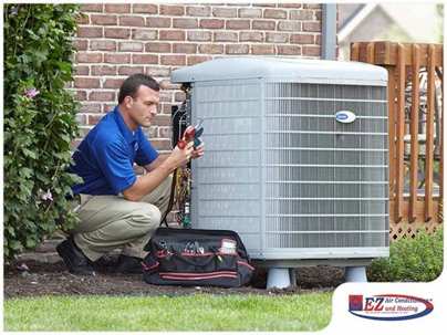 HVAC technician servicing a central air conditioning unit