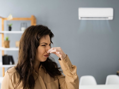 Woman holding her nose