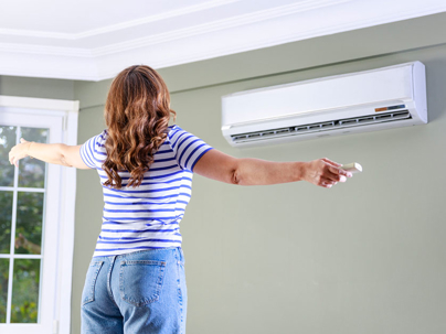 a woman enjoying the cold breeze from the AC