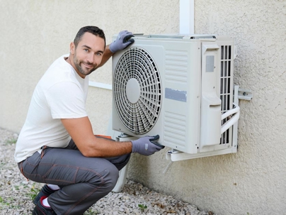 an HVAC tech checking the outdoor unit