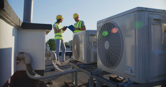 HVAC technicians checking the outdoor units