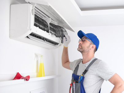 a professional technician checking the AC filters