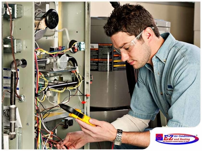 HVAC technician performing diagnostic work on a furnace or air handler unit
