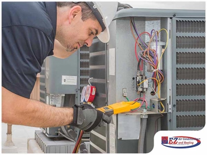 HVAC technician performing electrical diagnostics on a central air conditioning condenser unit