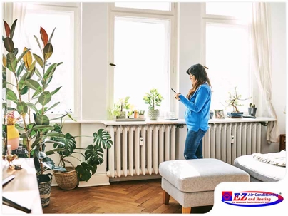 Woman standing beside the window