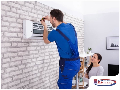 technician servicing the indoor unit of a mini-split air conditioning system